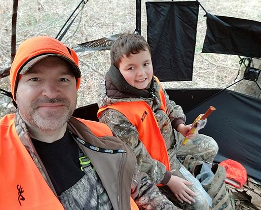 A father and son in hunting gear