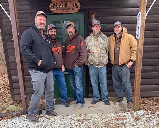 A group of veterans outside a hunting lodge
